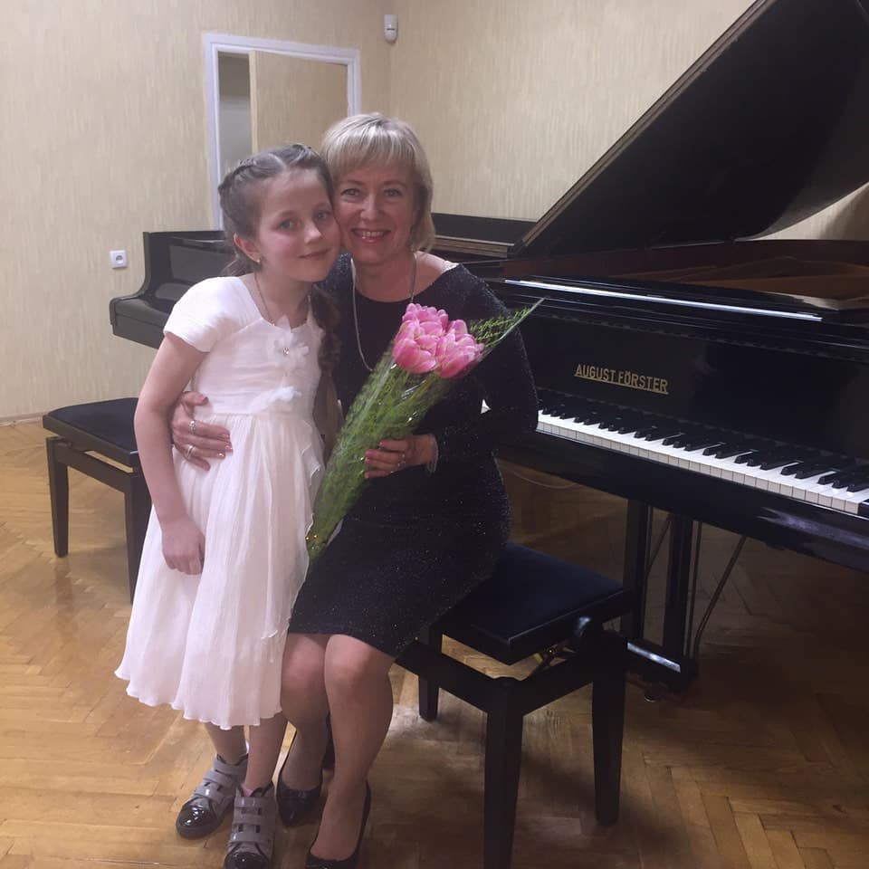 Larysa with student by the piano