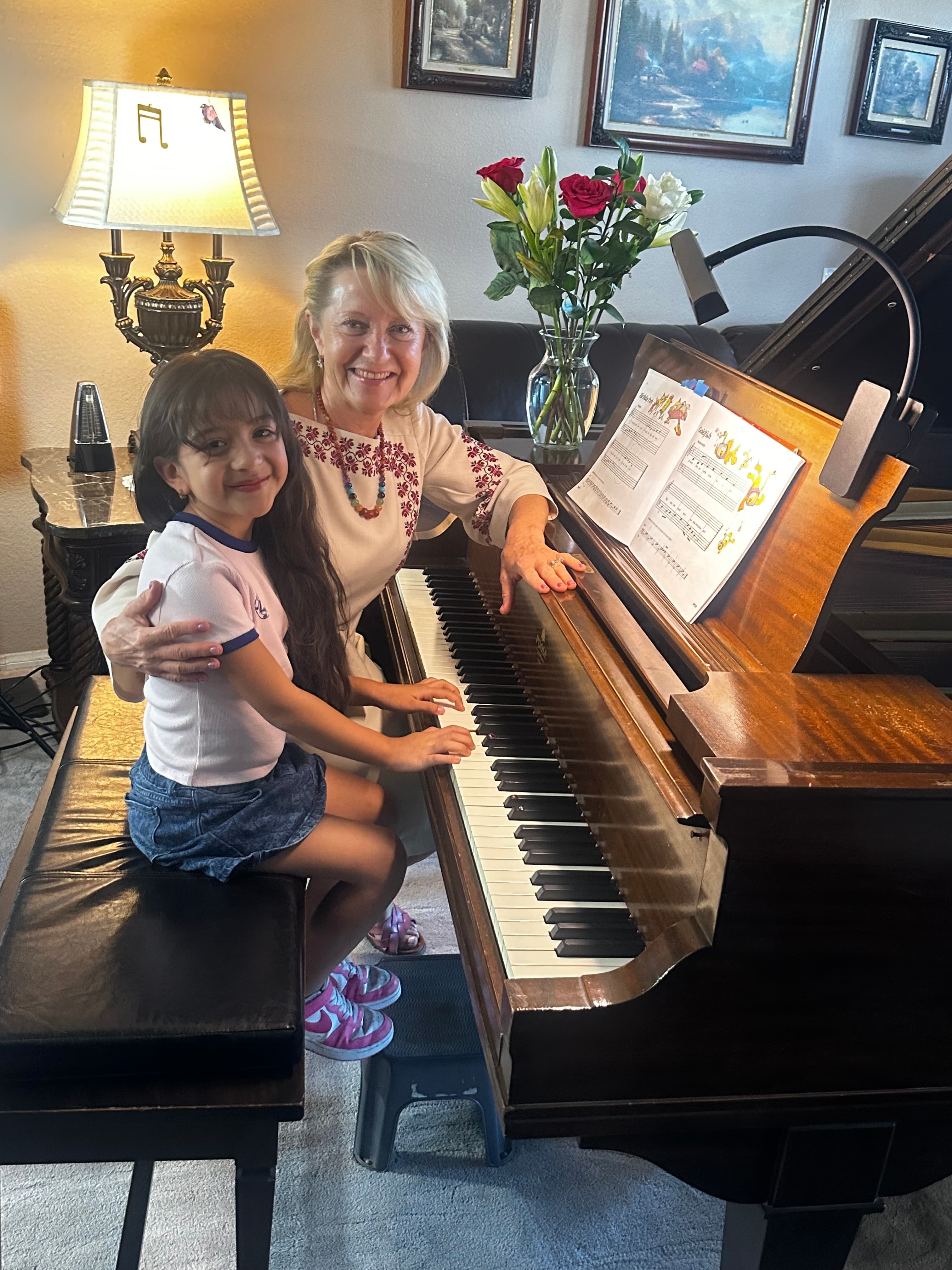 Larysa with student by the piano