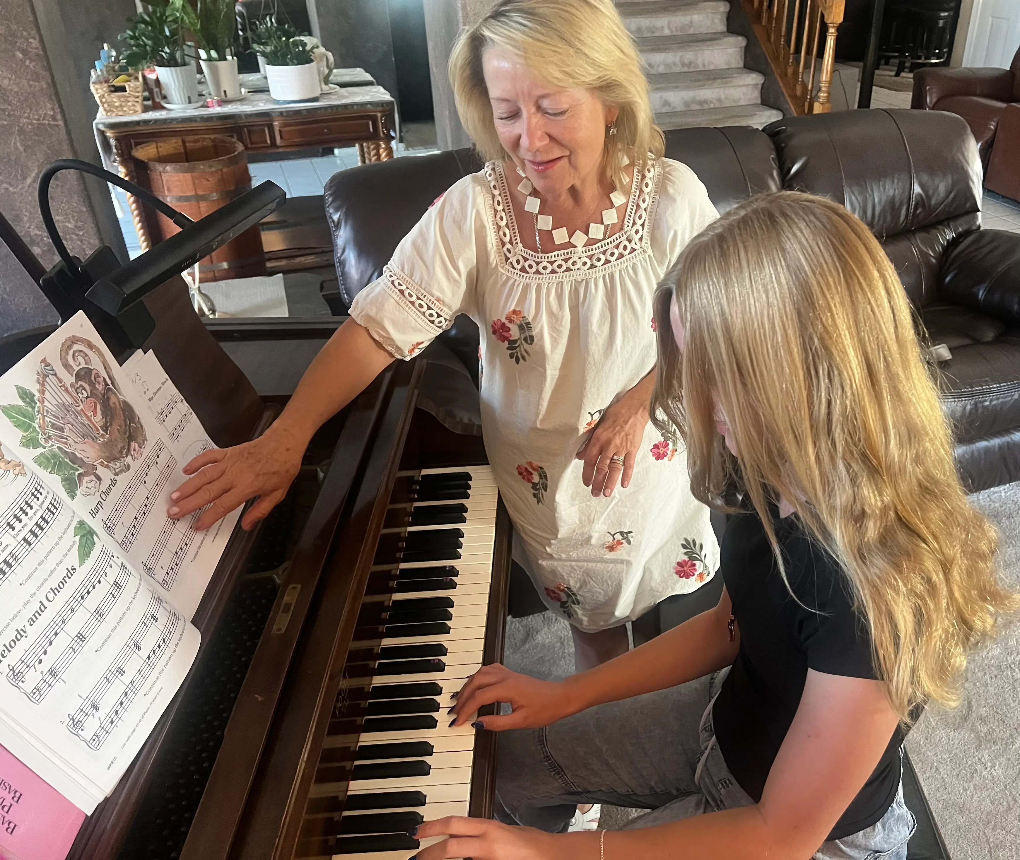 Larysa with student by the piano