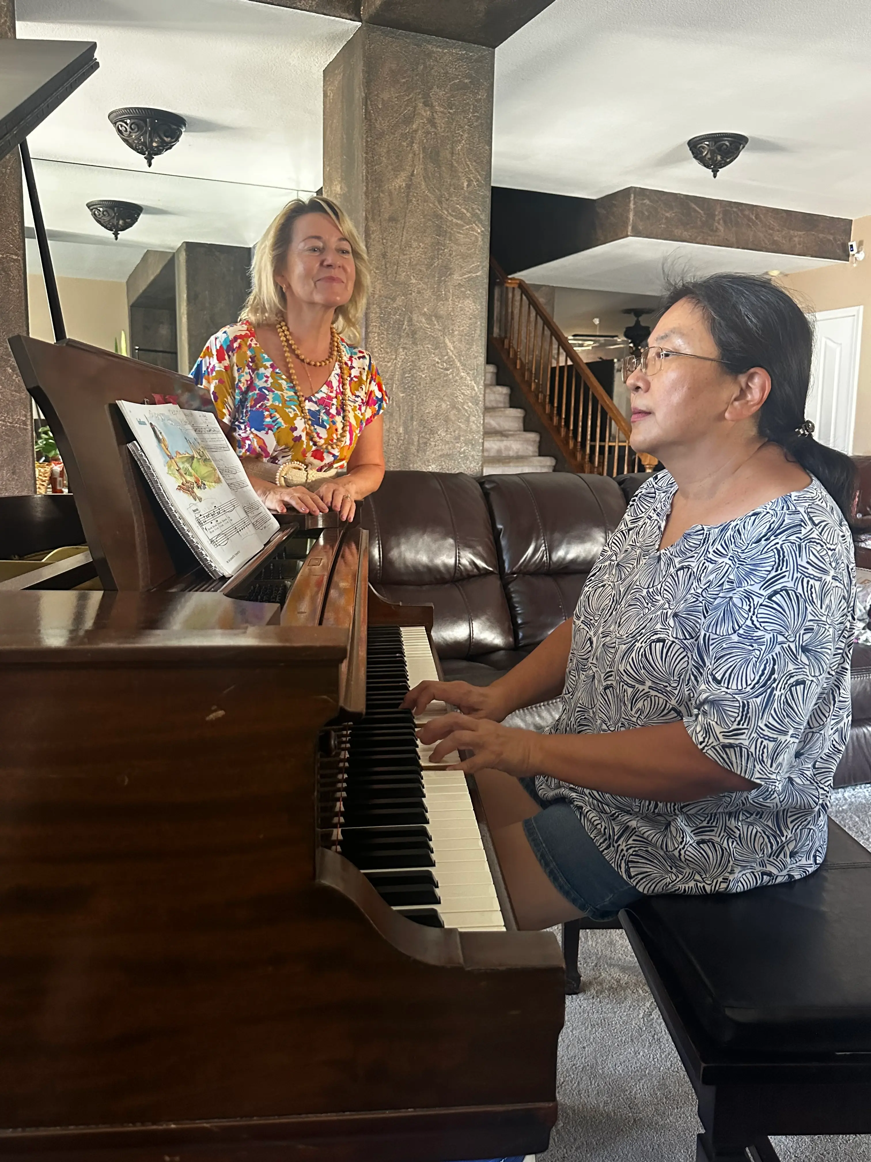 Larysa with student by the piano